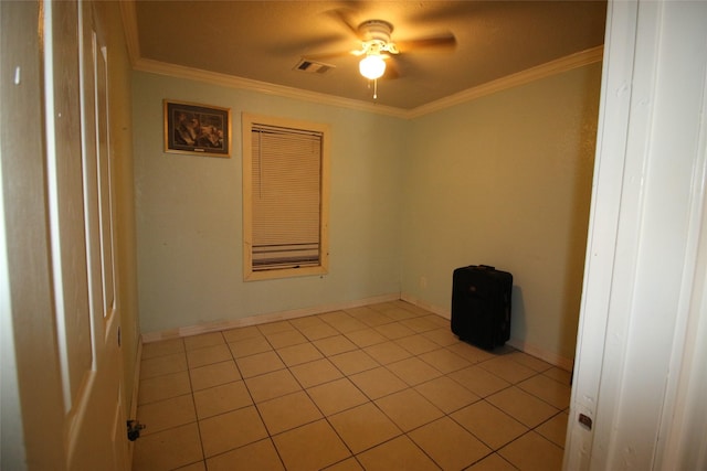 empty room with ceiling fan, visible vents, ornamental molding, and light tile patterned floors