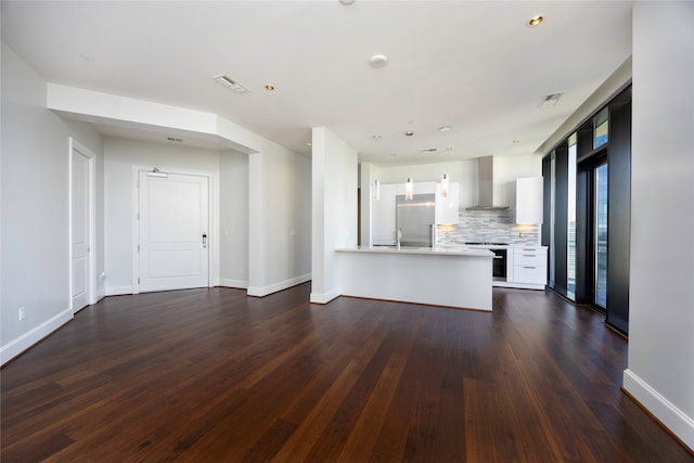 unfurnished living room featuring sink and dark wood-type flooring