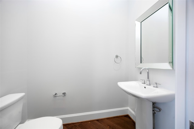 bathroom featuring hardwood / wood-style floors and toilet