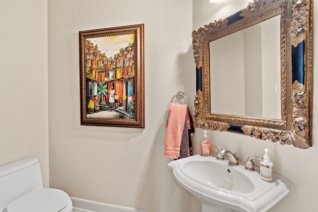 bathroom with toilet and sink