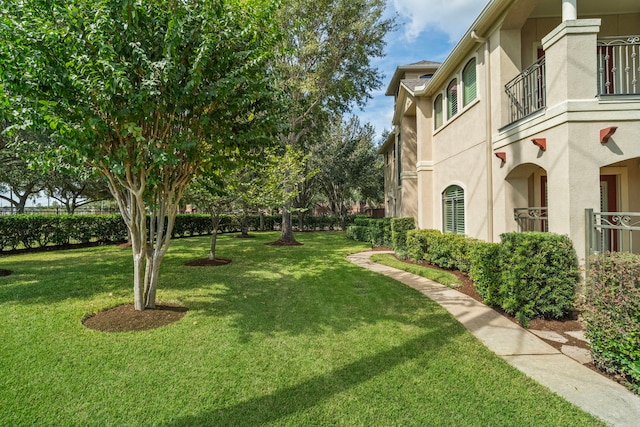 view of yard with a balcony