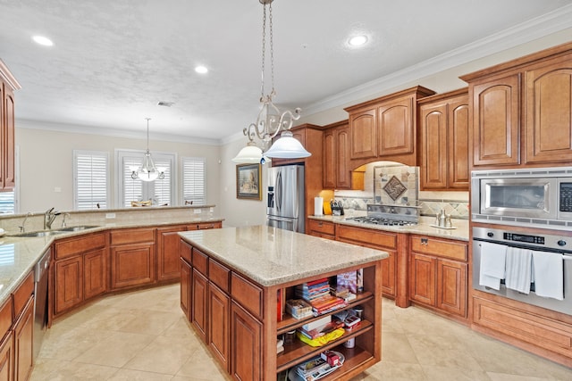 kitchen with sink, a center island, decorative light fixtures, a chandelier, and appliances with stainless steel finishes