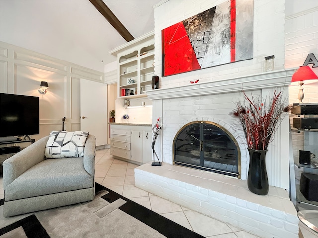 tiled living room featuring beamed ceiling and a fireplace