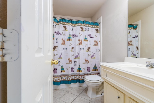 bathroom featuring walk in shower, vanity, toilet, and tile patterned floors