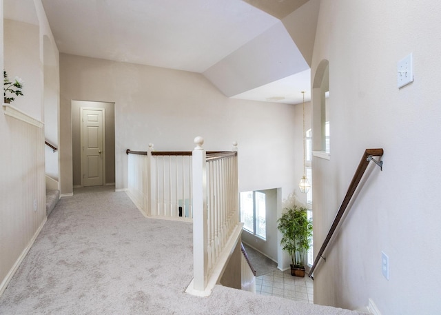 stairs featuring vaulted ceiling and carpet