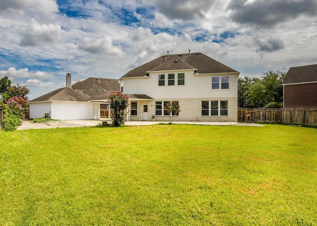 back of property featuring a yard and a patio area