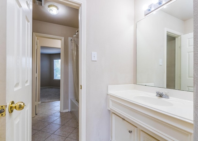 bathroom featuring vanity, tile patterned floors, shower / bath combo, and a textured ceiling