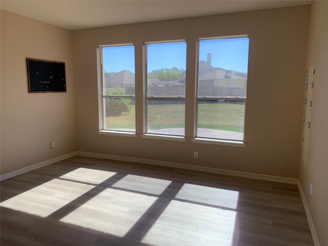 spare room with dark hardwood / wood-style flooring