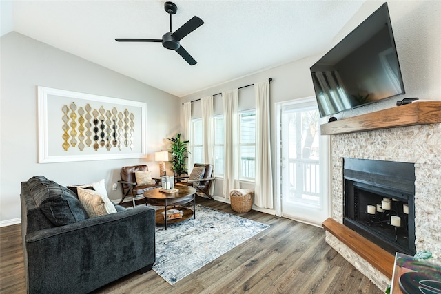 living room with ceiling fan, lofted ceiling, a fireplace, and hardwood / wood-style floors