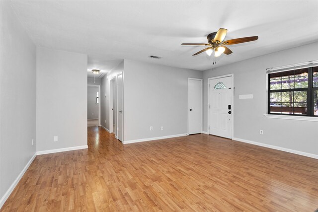 unfurnished room with light wood-type flooring and ceiling fan