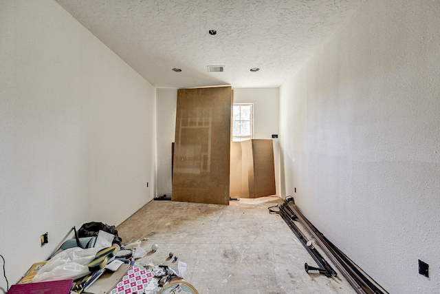 unfurnished room featuring a textured ceiling