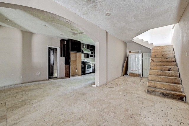 unfurnished living room featuring a textured ceiling