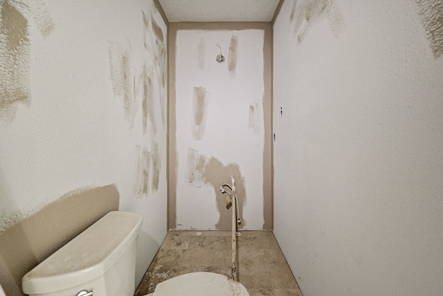 bathroom with a textured ceiling and toilet