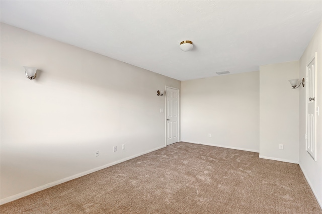 unfurnished room featuring light carpet