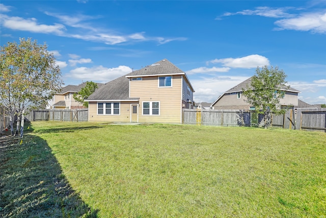 back of property featuring a lawn