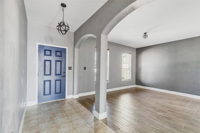 entryway featuring light hardwood / wood-style floors and a chandelier