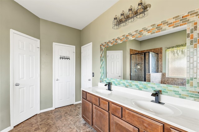 bathroom featuring vanity, decorative backsplash, and an enclosed shower