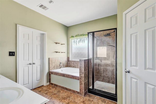 bathroom featuring vanity, independent shower and bath, and tile patterned flooring