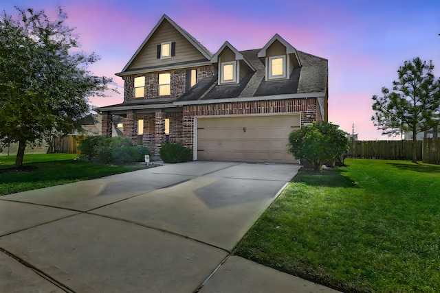 view of front facade with a yard and a garage