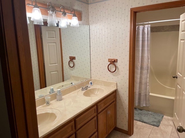 bathroom with shower / tub combo with curtain, vanity, and tile patterned flooring