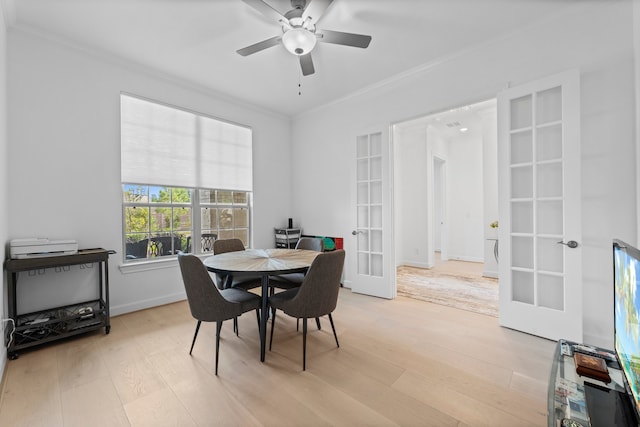 dining room featuring french doors, ceiling fan, ornamental molding, and light wood-type flooring