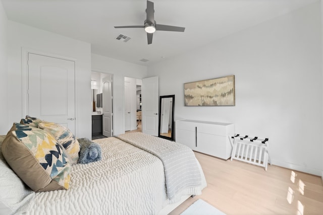 bedroom with light hardwood / wood-style flooring, connected bathroom, and ceiling fan