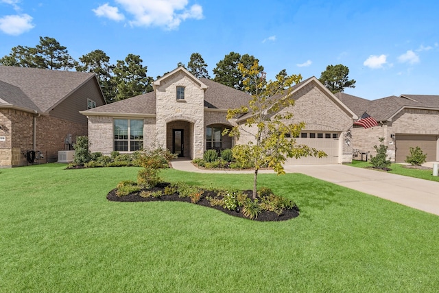 french country inspired facade featuring a front yard and a garage