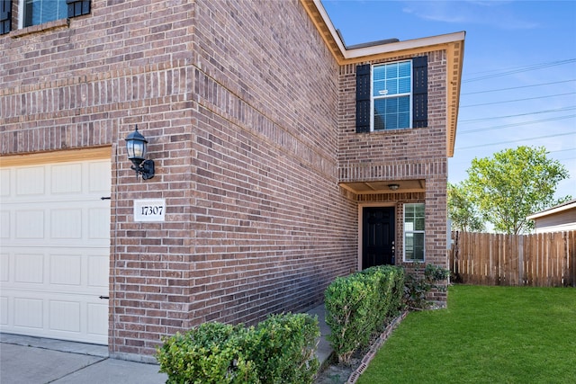 entrance to property with a yard and a garage