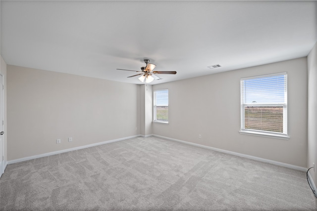 carpeted spare room with ceiling fan