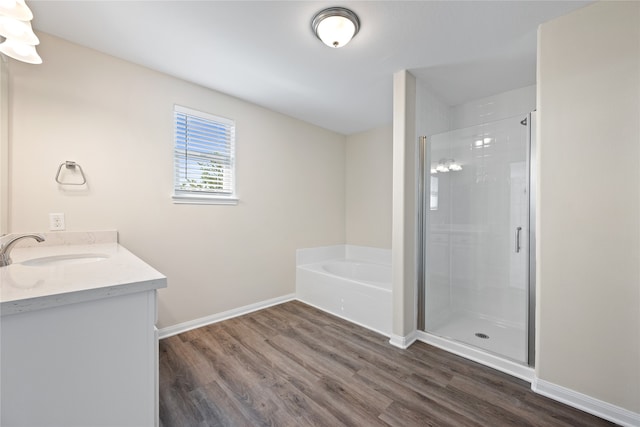 bathroom with vanity, hardwood / wood-style flooring, and independent shower and bath