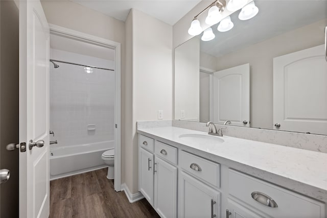 full bathroom featuring bathtub / shower combination, vanity, hardwood / wood-style flooring, and toilet