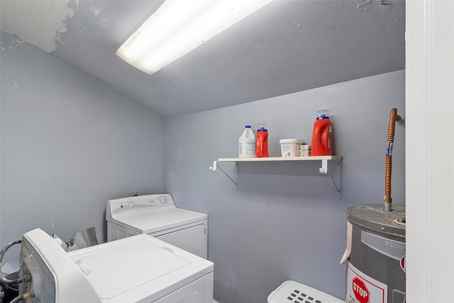 clothes washing area featuring independent washer and dryer and electric water heater