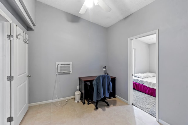 home office featuring a wall mounted air conditioner, light tile patterned floors, and ceiling fan