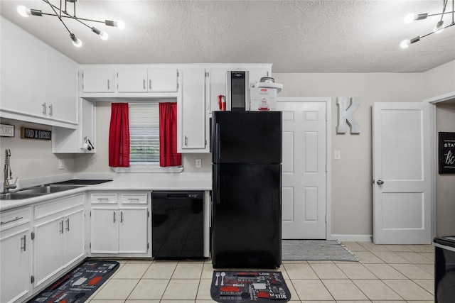 kitchen with a textured ceiling, black appliances, light tile patterned flooring, and white cabinets