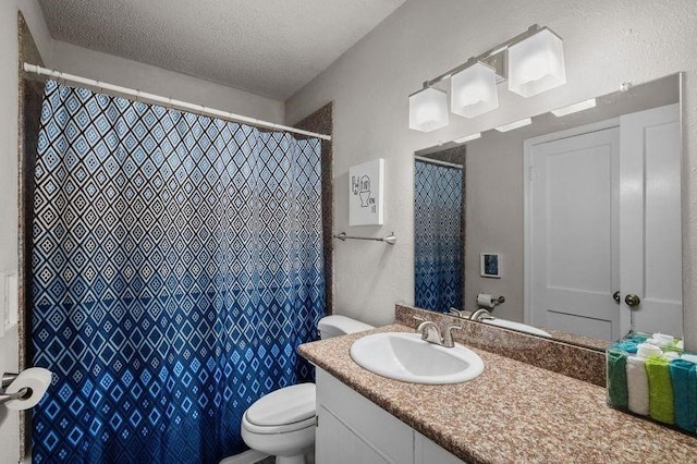 bathroom with vanity, a shower with shower curtain, a textured ceiling, and toilet