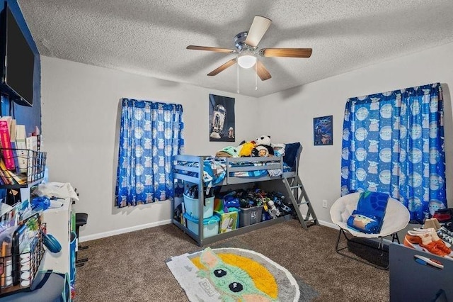 carpeted bedroom with ceiling fan and a textured ceiling