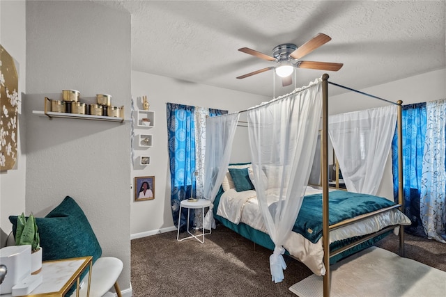 bedroom featuring dark carpet, a textured ceiling, and ceiling fan