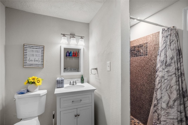 bathroom with vanity, a textured ceiling, a shower with curtain, and toilet