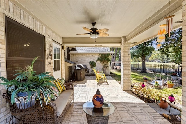 view of patio / terrace with ceiling fan and an outdoor living space