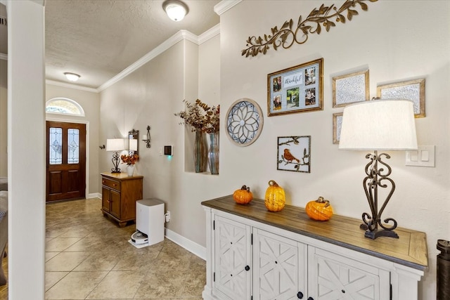 tiled foyer featuring crown molding and a textured ceiling