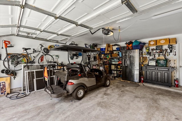 garage with stainless steel fridge with ice dispenser and a garage door opener