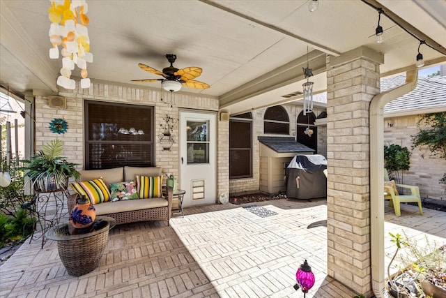 view of patio with ceiling fan and a grill