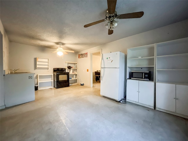 kitchen featuring black range oven, white fridge, a textured ceiling, and ceiling fan