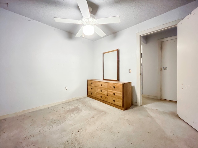 unfurnished bedroom featuring a closet, ceiling fan, and a textured ceiling