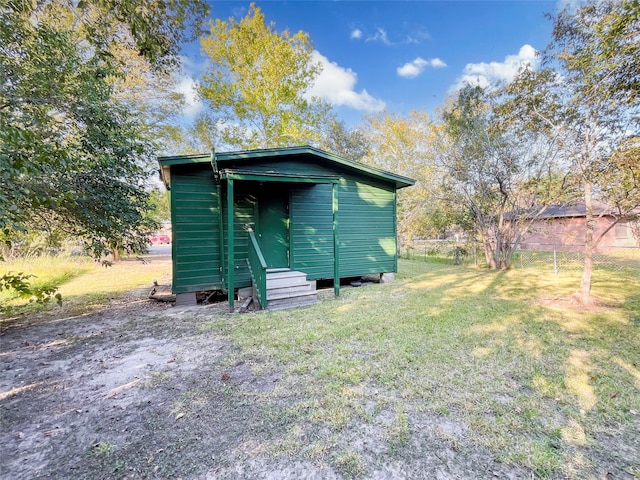 view of outbuilding with a yard