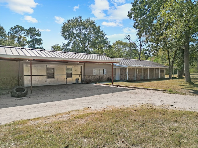 view of parking / parking lot featuring a lawn