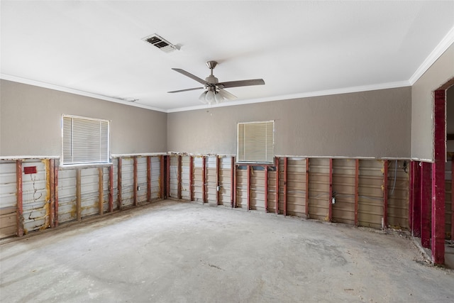 spare room with ceiling fan, ornamental molding, and concrete floors