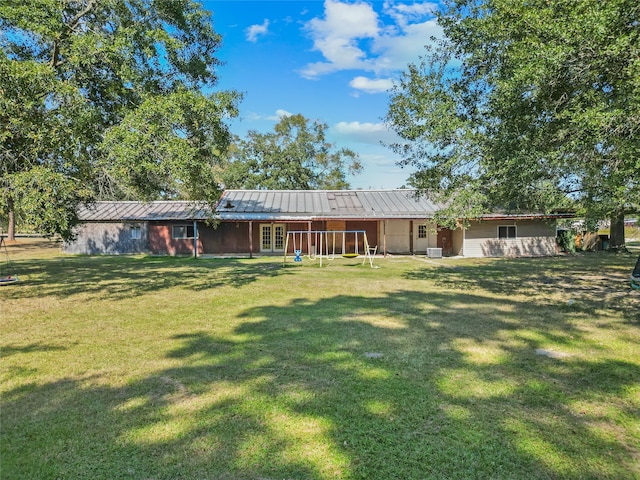 rear view of house featuring a lawn