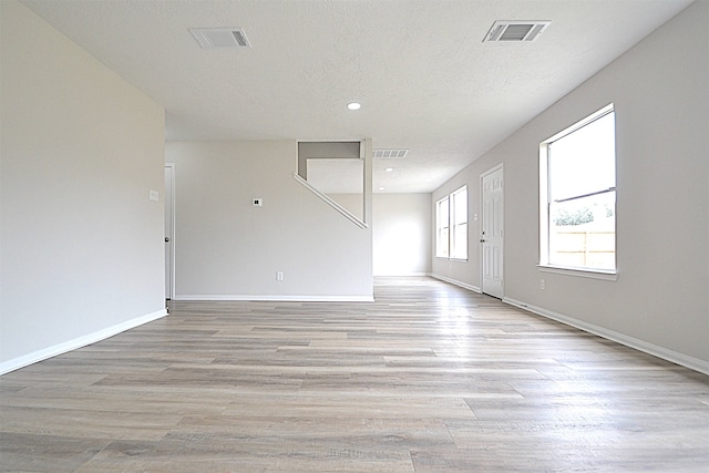 interior space with light hardwood / wood-style floors and a textured ceiling