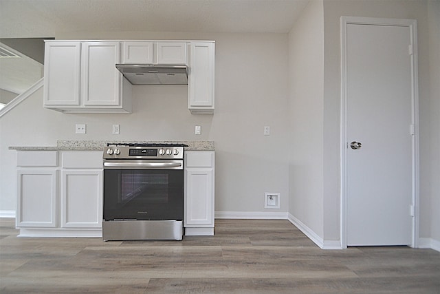 kitchen featuring white cabinetry, electric range, and light wood-type flooring